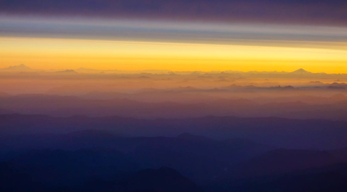 View from the summit, looking north. Glacier Peak on the right and Mt Baker on the left, rising above the North Cascades.