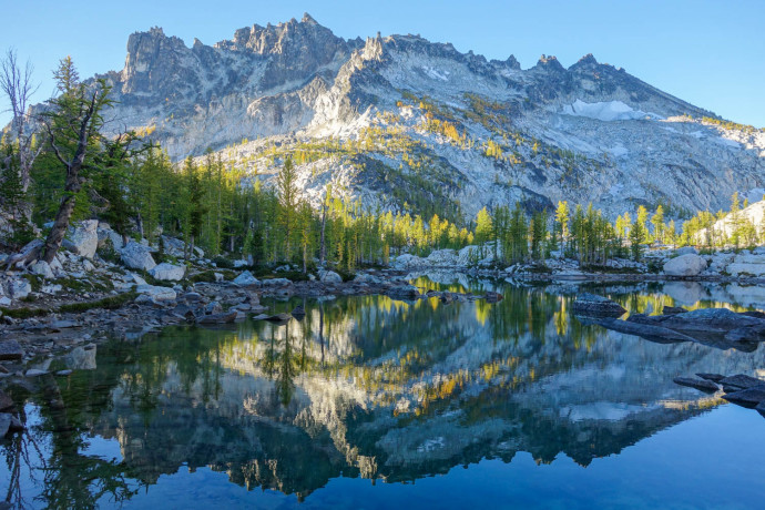 Still morning views of McClellan Peak reflected in Leprauchaun Lake. 