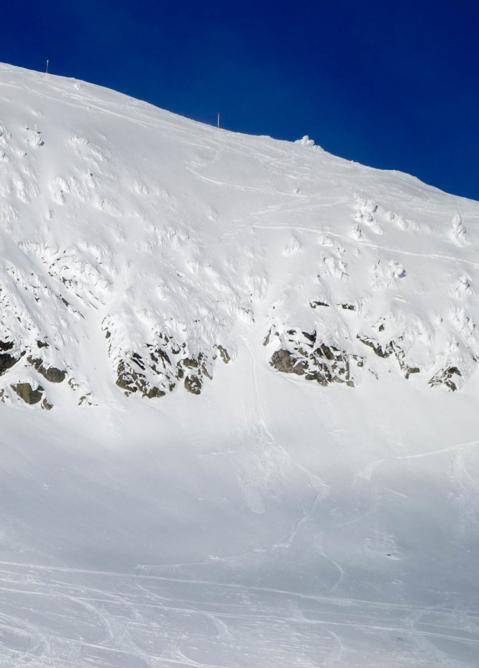 There was still goodness to be found at Big White. Ely found a fun line down these chutes on the backside, through the center chute here. You can also see where we wiped out when trying to slow down past the landing. 
